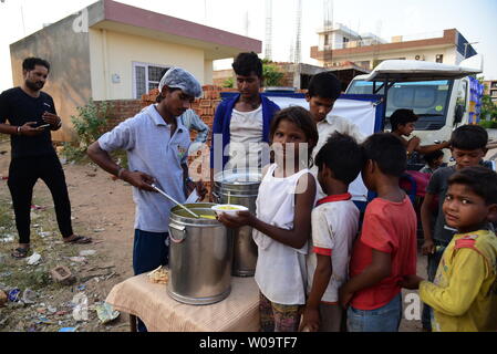 Poor children at a food distribution camp in New Delhi, India. Stock Photo