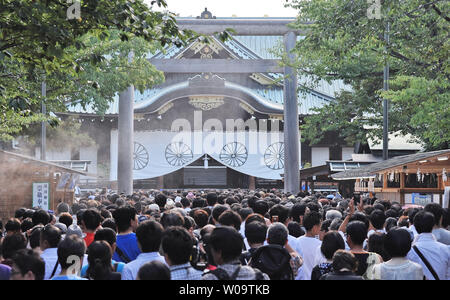 Worshipers visit  the Yasukuni Shrine  in Tokyo, Japan, on August 15, 2013.   The Yasukuni Shrine honors the 2.5 million Japanese war dead, and also houses a war museum that glorifies Japan's wartime past.  Emperor Akihito's father Emperor Hirohito surrendered to allied forces on August 15, 1945.    UPI/Keizo Mori Stock Photo