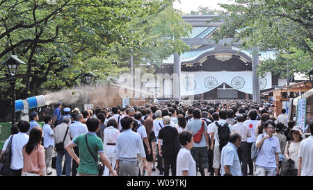 Worshipers visit the Yasukuni Shrine  in Tokyo, Japan, on August 15, 2013.   The Yasukuni Shrine honors the 2.5 million Japanese war dead, and also houses a war museum that glorifies Japan's wartime past.  Emperor Akihito's father Emperor Hirohito surrendered to allied forces on August 15, 1945.    UPI/Keizo Mori Stock Photo
