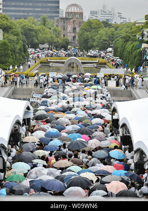 People pray for the atomic bomb victims at Hiroshima Peace Memorial Park marking the 69th anniversary of the atomic bombing in Hiroshima, Japan, on August 6, 2014.   An American B-29 dropped an atomic bomb on Hiroshima killing tens of thousands and hastening the end of World War II.   UPI/Keizo Mori Stock Photo