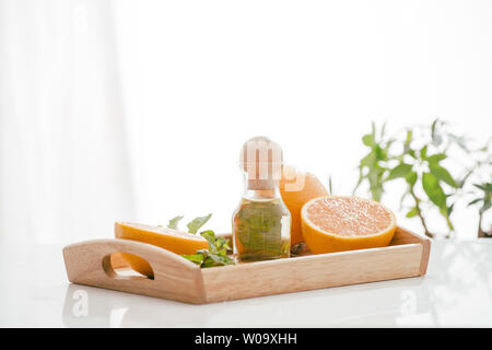 Natural cosmetic skincare serum packaging with leaf fern and fresh juicy  orange fruit on white background. Beauty vitamin ingredient. alternative  medi Stock Photo - Alamy