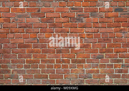 Close up of an old brick wall. This exterior wall is about 80 years old and shows the effects of weathering. Stock Photo