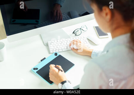 Young female designer using graphics tablet Stock Photo