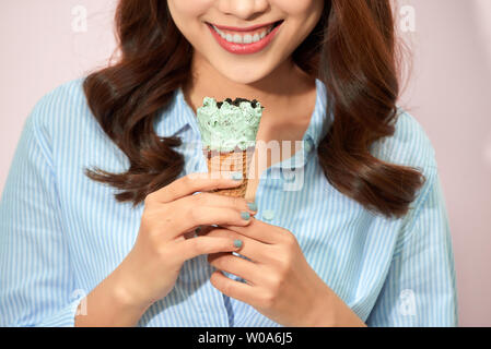 Sweet happy moments of attractive fashionable young woman having fun with cone ice cream on pink background. Dreaming, delicious, enjoying, happiness, Stock Photo