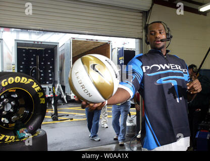 Cleveland Cavaliers basketball star LeBron James spins a basketball as he films an interview while visiting a garage at Bristol Motor Speedway before the start of the NASCAR Nextel Cup Series Sharpie 500  in Bristol, TN on August 27, 2005.  (UPI Photo/Nell Redmond) Stock Photo