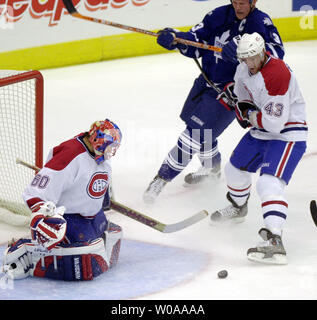 Montreal Canadiens goalie Jose Theodore and defenseman Patrice Brisebois try to hold off Toronto Maple Leafs captain Mats Sundin in front of the Montreal net in first period action at the AIr Canada Center in Toronto, Canada on Oct. 11, 2003.   (UPI/Christine Chew) Stock Photo