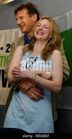 Laura Linney and Liam Neeson clown around for photographers before the press conference for 'Kinsey' at the Four Seasons Hotel during the Toronto International Film Festival September 13, 2004 in Toronto, Canada. 'Kinsey' had its world premiere screening at the Festival the previous night. (UPI Photo/Christine Chew) Stock Photo