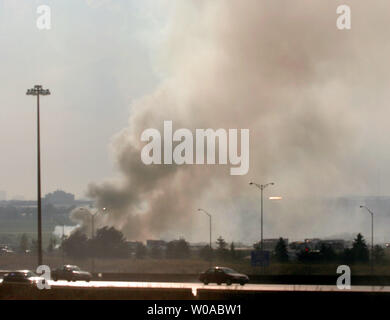 Smoke billows from the wreckage of Air France flight 358 after it skidded nose-first into a ravine and broke into two pieces just off a major highway on landing during a torrential downpour at Pearson International Airport in Toronto, Canada August 2, 2005. Miraculously, all 297 passengers and 12 crew members on the flight survived the crash with over 40 people reported suffering various injuries. (UPI Photo/Christine Chew) Stock Photo