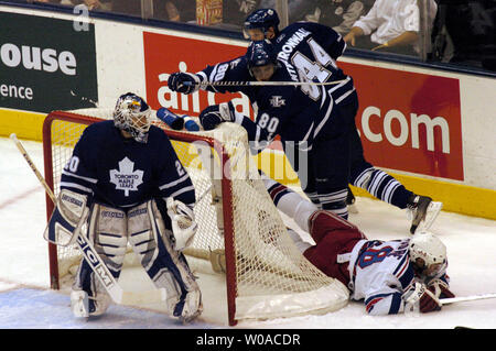 Toronto Maple Leafs' goalie Ed Belfour looks on as New York Rangers' Dominic Moore collides with Leafs' Nik Antropov and  Staffan Kronwall behind the Leaf net during first period action at the Air Canada Center in Toronto, Canada on November 15, 2005. The Leafs went on to defeat the Rangers 2-1. (UPI Photo/Christine Chew) Stock Photo