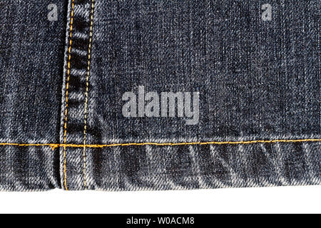 Piece of dark jeans fabric isolated on white background. Rough uneven edges. Stock Photo