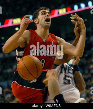 Toronto Raptors' Jose Calderon of Spain gets fouled by New Jersey Nets' Eddie House during second quarter action at the Air Canada Center in Toronto, Canada on February 14, 2007. The Raptors defeated the Nets 120-109. (UPI Photo/Christine Chew) Stock Photo