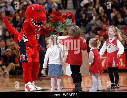 The Raptor, mascot of the Toronto Raptors, receives flowers from young fans during the Valentine's Day game against the New Jersey Nets at the Air Canada Center in Toronto, Canada on February 14, 2007. The Raptors defeated the Nets 120-109. (UPI Photo/Christine Chew) Stock Photo