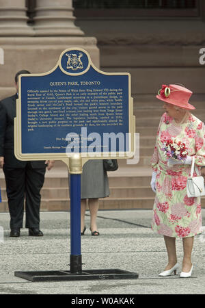Great Britain's Queen Elizabeth unveils a bronze plaque commemorating the 2010 Royal visit as she and Prince Philip attend their official departure ceremony at Queen's Park in Toronto, Ontario, July 6, 2010. The Royal couple are leaving for the United States after their nine day Royal Tour of Canada.  UPI/Heinz Ruckemann Stock Photo