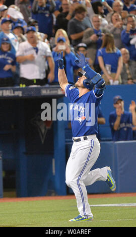 Toronto Blue Jays Josh Donaldson (L), Troy Tulowitzki (C), and Ryan Goins  celebrate defeating the Cleveland Indians in game four of the American  League Championship Series at Rogers Centre on October 18