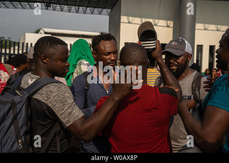 Migrants argue in front of (INM) Instituto Nacional de Migración Delegación Federal en Chiapas in Tapachula, Mexico on May 6, 2019.  ension has been building due to the length of time it is taking to start the process for an exit Visa.     Photo by Ariana Drehsler/UPI Stock Photo