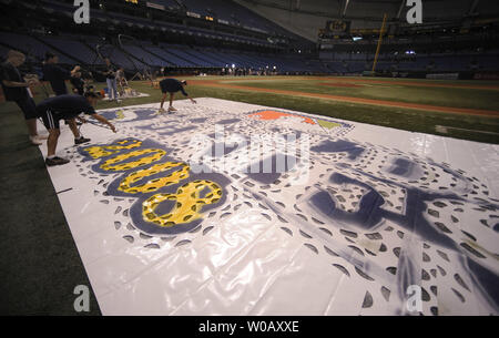 Members of the grounds crew paint the World Series logo on