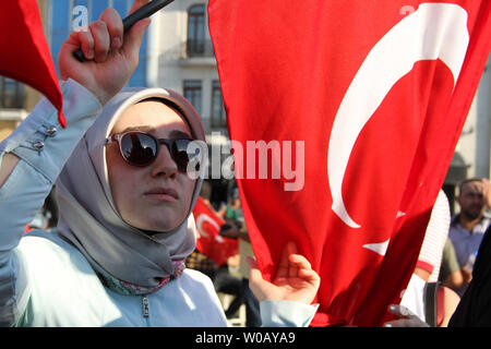 A veiled woman holds a Turkish flag during a demonstration in Istanbul in support the government on July 16, 2016, following a failed coup attempt. Turkish authorities said they had regained control of the country on July 16 after thwarting a coup attempt by soldiers In the army against President Recep Tayyip Erdogan that claimed more than 250 lives. photo by Hanna Noori/ UPI Stock Photo
