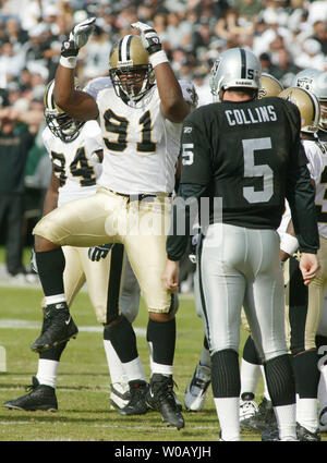 New Orleans Saints Will Smith (91) does a little taunting dance in front of Oakland Raiders QB Kerry Collins following a tackle at the Network Associates Coliseum in Oakland, CA on October 24, 2004.     (UPI Photo/Terry Schmitt) Stock Photo