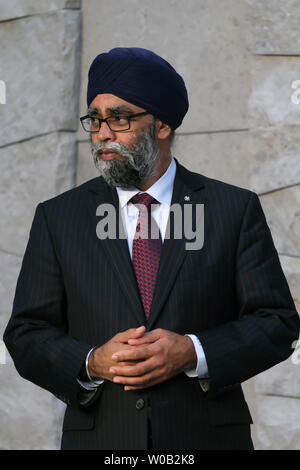 Canadian Defense Minister Harjit Singh Sajjan, center, attends a ...