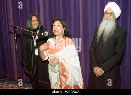 Writer/director Deepa Mehta (L) invites local actors Balinder Johal and Rajinder Singh Cheema (R) to the microphone to help her introduce their latest film 'Heaven on Earth' screening at the Empire Granville 7 Theater during the Vancouver International Film Festival in Vancouver, British Columbia, October 4, 2008.  (UPI Photo/Heinz Ruckemann) Stock Photo