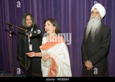 Writer/director Deepa Mehta (L) invites local actors Balinder Johal and Rajinder Singh Cheema (R) to the microphone to help her introduce their latest film 'Heaven on Earth' screening at the Empire Granville 7 Theater during the Vancouver International Film Festival in Vancouver, British Columbia, October 4, 2008.  (UPI Photo/Heinz Ruckemann) Stock Photo