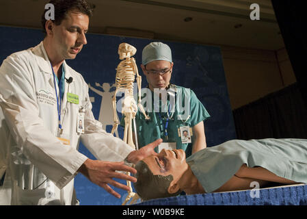 University of British Columbia (UBC) and Vancouver General Hospital (VGH) medical student David Tso (R.) and VGH Director of Trauma Imaging Dr. Savvas Nicolaou demonstrate new technology including iPad and iPhone applications being used by the Emergency Department at VGH during the official opening of the two day Year of Science, Science and Health Expo at the Fairmont Waterfront Hotel in downtown Vancouver, BC, on November 25, 2010. The Expo hopes to inspire high school students to choose careers in health sciences and bio technology.   UPI/Heinz Ruckemann Stock Photo