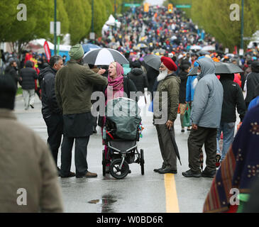 Liberal Prime Minister Justin Trudeau walks in the Vaisakhi parade in wet, windy weather after speaking at the Khalsa Diwan Society's Ross Street Temple during Vaisakhi celebrations in Vancouver, British Columbia on April 13, 2019, after his government recently removed a reference to Sikh extremism from a 2018 terrorism report. Tens of thousands of people attend this annual Punjabi harvest festival which commemorates the founding of the Khalsa in 1699 by Guru Gobind Singh and is one of the largest in North America. Photo by Heinz Ruckemann/UPI Stock Photo