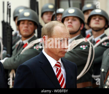 Russian President Vladimir Putin reviews a guard of honor during a ...