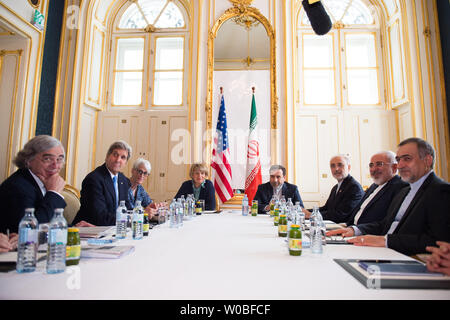 U.S. Secretary of State John Kerry, flanked by National Security Council Senior Director for Iran, Iraq, Syria and the Gulf States Robert Malley, U.S. Energy Secretary Dr. Ernest Moniz, Under Secretary of State for Political Affairs Wendy Sherman, and European Union Deputy Secretary General Helga Schmid, addresses reporters as he sits across from Iranian Foreign Minister Javad Zarif, Dr. Ali Akbar Salehi, the Vice President of Iran for Atomic Energy and President of the Atomic Energy Organization of Iran, and other advisers on July 3, 2015 in Vienna, Austria.  The talks have reached the critic Stock Photo