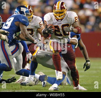 Washington Redskins Clinton Portis (26) breaks the tackle of New York Jets  Victor Hobson (54) in the first quarter at Giants Stadium in East  Rutherford, New Jersey on November 4, 2007. The