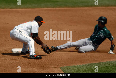 Miguel Tejada (L) of the Baltimore Orioles tags out the Tampa Bay Devil Rays Julio Lugo (R) on an attempted steal in the second inning on May 1, 2005 in a game won by the Orioles 7-4 at Orioles Park at Camden Yards in Baltimore, MD.  (UPI Photo/Mark Goldman) Stock Photo