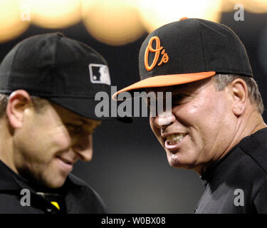 Baltimore Orioles manager Dave Trembley (R) comes out to argue with home plate umpire Chris Guccione (L) after left fielder Jay Payton was called out a home to end the fifth inning against the Minnesota Twins at Orioles Park at Camden Yards in Baltimore on August 24, 2007.  (UPI Photo/Mark Goldman) Stock Photo