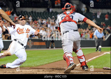 The Baltimore Orioles' Chris Davis (19) loses his footing after swinging  for his third strike at Oriole Park at Camden Yards in Baltimore, Maryland,  on Tuesday, September 27, 2011. The ball evaded