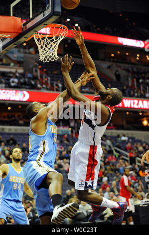 Washington Wizards small forward Chris Singleton (31) scores and is fouled by Denver Nuggets power forward Darrell Arthur (00) in the first half at the Verizon Center in Washington, D.C. on December 9, 2013.   UPI/Mark Goldman Stock Photo