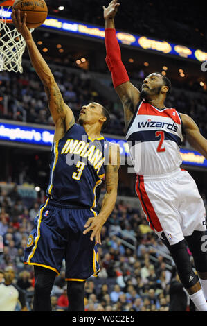Indiana Pacers guard George Hill (3) scores against Washington Wizards guard John Wall (2) on a fast break in the first half at the Verizon Center in Washington, D.C. on March 28, 2014.   UPI/Mark Goldman Stock Photo