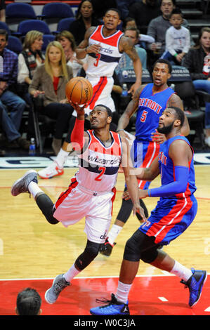 Washington Wizards guard John Wall (2) scores and is fouled by Detroit Pistons guard Reggie Jackson (1) in the first half at the Verizon Center in Washington, D.C. on February 28, 2015.   Photo by Mark Goldman/UPI Stock Photo