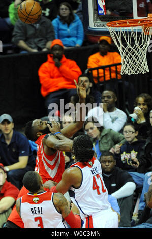 Houston Rockets center Nene Hilario, center, holds the ball defended by ...