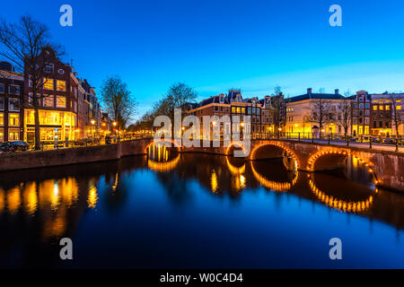 Canals of Amsterdam at night. Amsterdam is the capital and most populous city of the Netherlands. Stock Photo