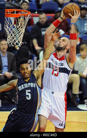 Washington Wizards center Marcin Gortat (13) dunks the ball against Memphis Grizzlies guard Courtney Lee (5) in the first half at the Verizon Center in Washington, D.C. on December 23, 2015.   Photo by Mark Goldman/UPI Stock Photo