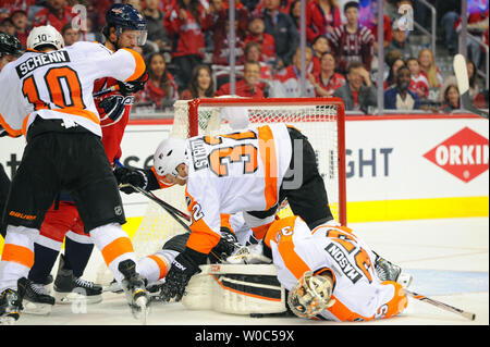 Philadelphia Flyers goalie Steve Mason (35) and defenseman Mark Streit (32) block a shot by Washington Capitals right wing Justin Williams (14) in the third period at the Verizon Center in Washington, D.C. on April 16, 2016, in the second game of the first round of the Stanley Cup playoffs.  The Washington Capitals defeated the Philadelphia Flyers. 4-1, to take a two to nothing series lead. Photo by Mark Goldman/UPI Stock Photo