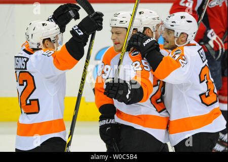 Philadelphia Flyers center Ryan White (25) celebrates his goal with center Nick Cousins (52) and defenseman Mark Streit (32) against the Washington Capitals in the second period at the Verizon Center in Washington, D.C. on April 22, 2016, in the fifth game of the first round of the Stanley Cup playoffs.  Photo by Mark Goldman/UPI Stock Photo