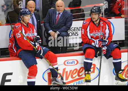 Washington Capitals head coach Barry Trotz sits between Washington Capitals left wing Andre Burakovsky (65) and left wing Alex Ovechkin (8) as the winning goal is reviewed against the Pittsburgh Penguins at the Verizon Center in Washington, D.C. on April 28, 2016, in the first game of the second round of the Stanley Cup playoffs. The Washington Capitals defeated the Pittsburgh Penguins, 4-3 in overtime. Photo by Mark Goldman/UPI Stock Photo