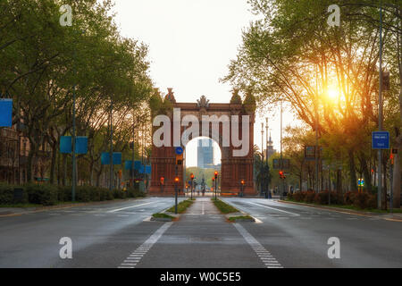 Bacelona Arc de Triomf during sunrise in the city of Barcelona in Catalonia, Spain. The arch is built in reddish brickwork in the Neo-Mudejar style Stock Photo
