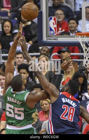 Boston Celtics center Greg Monroe (55) scores against Washington Wizards center Ian Mahinmi (28) in the first half at Capital One Arena in Washington, D.C. on April 10, 2018.  Photo by Mark Goldman/UPI Stock Photo