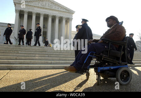 Jackson Hattfield sits in front of the U.S. Supreme Court Building after protesting against the case of Tennessee vs. Lane on January 13, 2004 in Washington.  The case deals with the civil rights of Americans with disabilities, after a Tennessee man was made to crawl up the stairs of a court house because it did not offer him what he felt was proper facilities. (UPI Photo/Michael Kleinfeld) Stock Photo