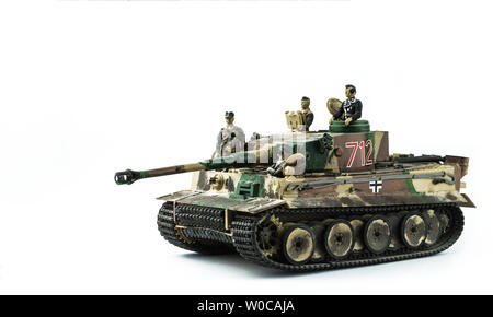 Old toy. Military tank with soldiers. Isolated on a white background. Stock Photo