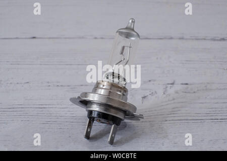 One motor vehicle automotive halogen car light bulb or lamp. Angled on a white painted board. Stock Photo