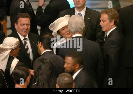 Former President Bill Clinton talks with foreign leaders and dignitaries prior to State Funeral for former President Ronald Reagan at the National Cathedral in Washington June 11, 2004.  At left is German Chancellor Gerhard Schroeder and at right is British Prime Minister Tony Blair.  Leaders of the world paid tribute to the 40th president of the United States.  (UPI Photo/Pat Benic)