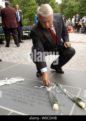Rep. Elton Gallegly, R-CA, lays a rose on the newly unveiled Vietnam Veterans Memorial Plaque on July 8, 2004, on the Mall in Washington. The plaque reads 'In memory of the men and women who served in teh Vietnam war and later died as a result of their service. We honor and remember their sacrifice.' Stock Photo