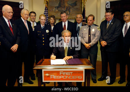 President George W. Bush and Laura Bush are surrounded by members of the New  Orleans Saints